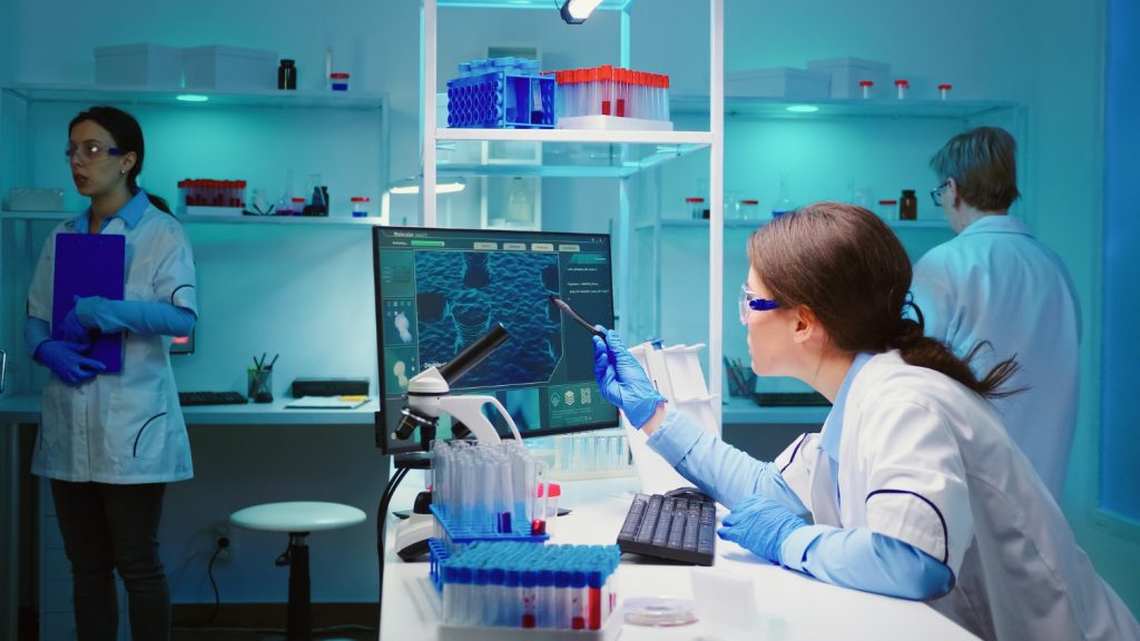 NHS staff working in a global medical diagnostics laboratory with advanced testing equipment