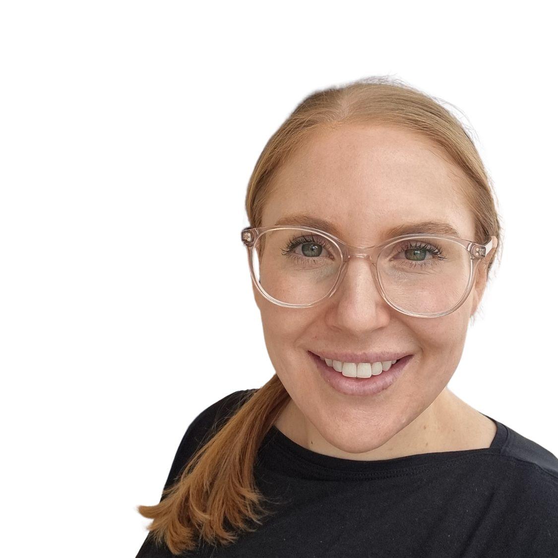 A person wearing glasses and smiling

AI-generated content may be incorrect.