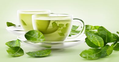 Glass cups with green tea and tea leaves isolated on white