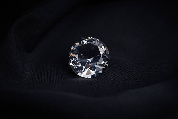 diamonds on black cloth close up.