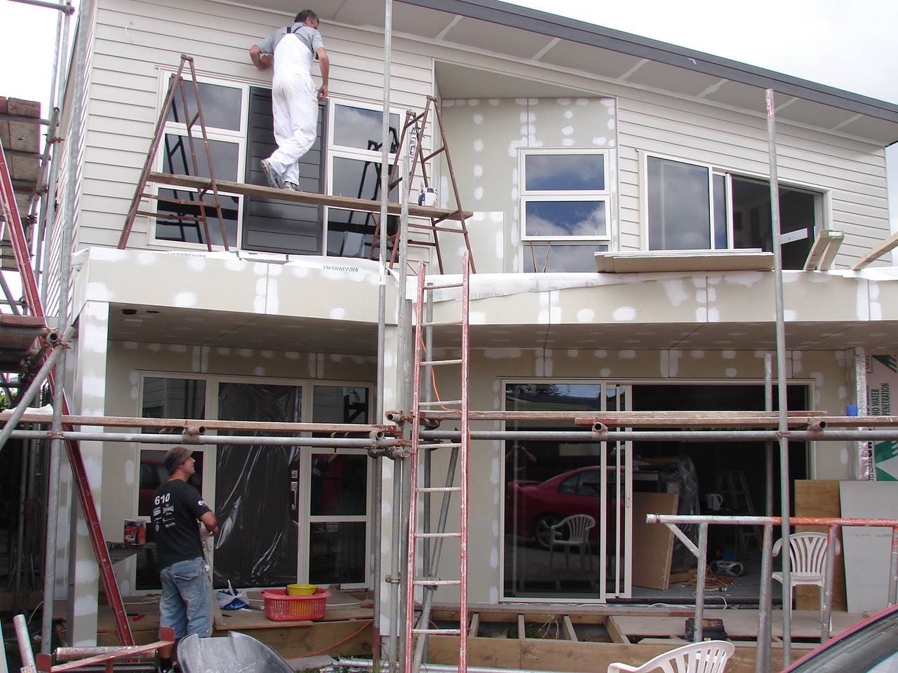 "Professional Gib lining service Auckland workers installing plasterboard on interior walls and ceilings"