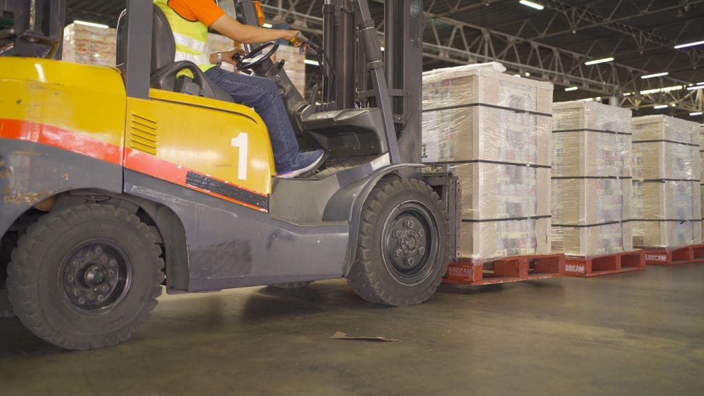 Fork lift truck with pallet car vehicle working of large warehouse retail store industry.