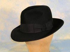 Film Noir Hats Crossword Clue
