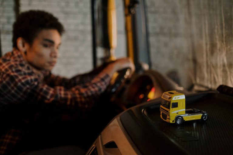 Photo by cottonbro studio: https://www.pexels.com/photo/yellow-miniature-toy-truck-on-black-surface-7541988/